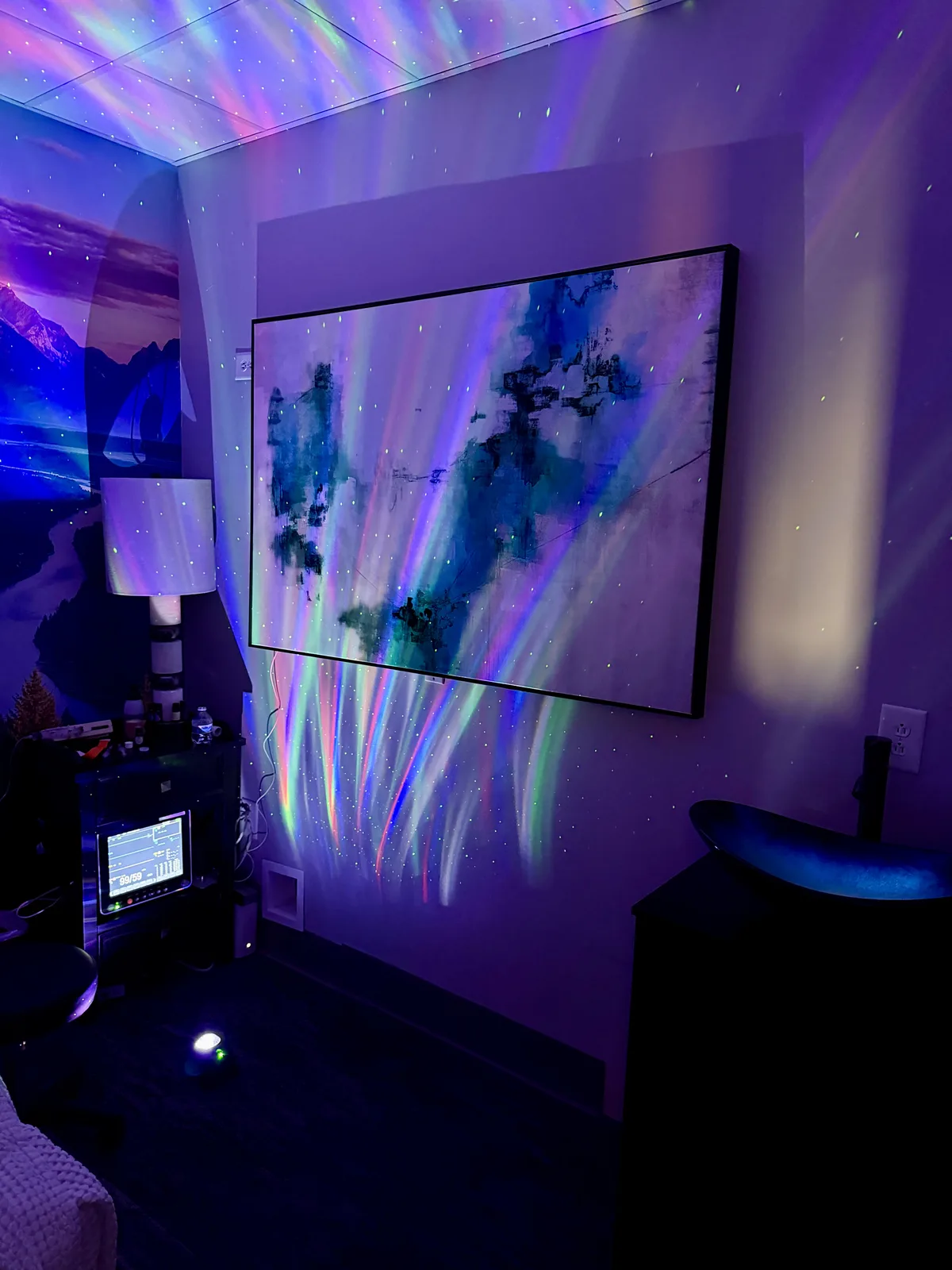 Music City Ketamine treatment room with blue and purple projected lighting and abstract wall art